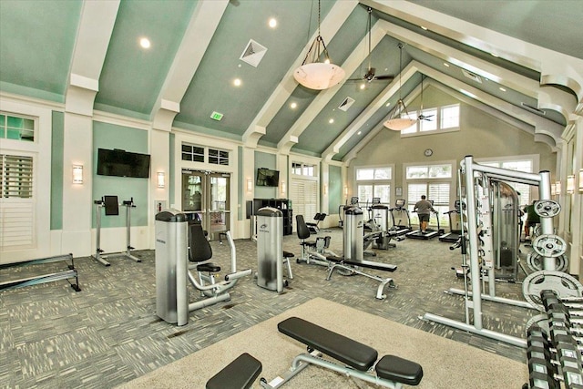 gym with visible vents, french doors, high vaulted ceiling, and carpet