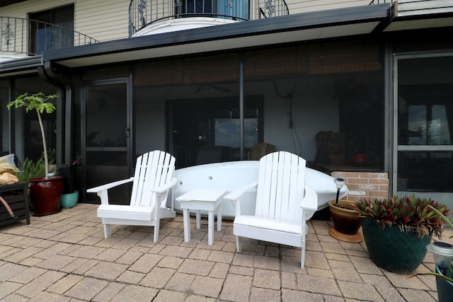 5 N Ocean Palm Villas Unit 5, Flagler Beach, FL 32136 - view of patio with a balcony, a sunroom, and outdoor dining space