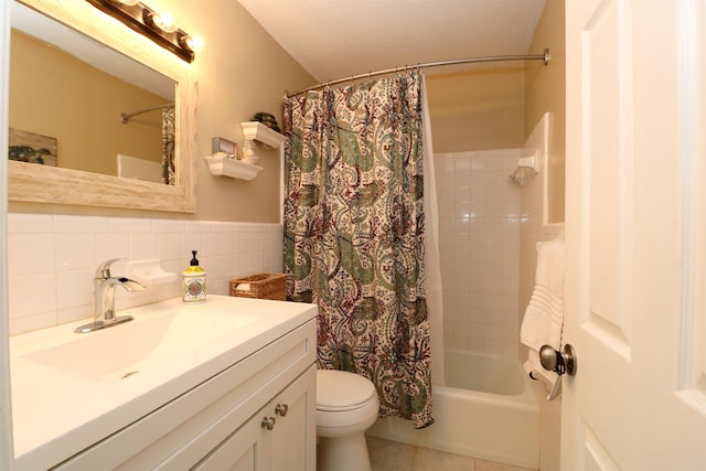 5 N Ocean Palm Villas Unit 5, Flagler Beach, FL 32136 - full bath with toilet, tile patterned floors, shower / tub combo, wainscoting, and vanity