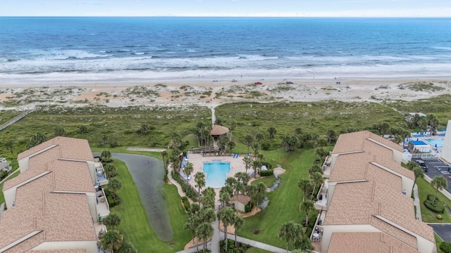 bird's eye view with a water view and a beach view