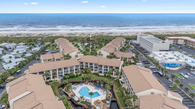 drone / aerial view featuring a view of the beach and a water view