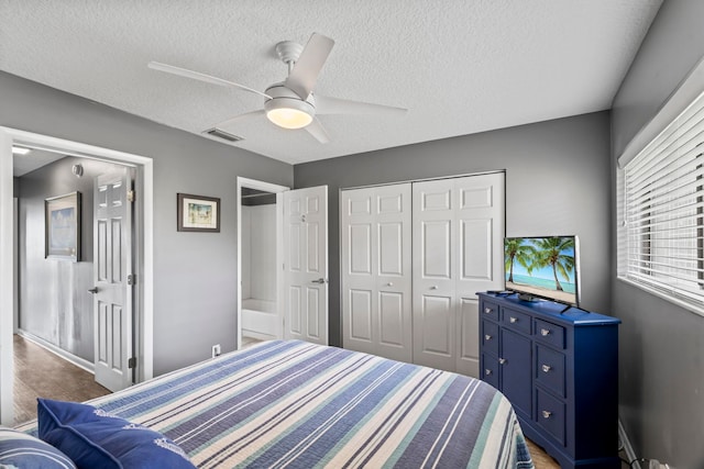 bedroom with ceiling fan, a textured ceiling, and a closet