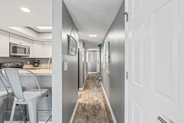 850 A1A Beach Blvd Unit 3, Saint Augustine Beach, FL 32080 - corridor with dark wood-style floors and a textured ceiling