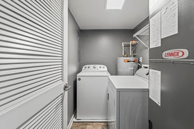 clothes washing area with washer and dryer, electric water heater, and heating unit