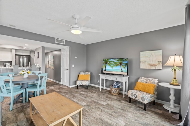 850 A1A Beach Blvd Unit 3, Saint Augustine Beach, FL 32080 - living room with a ceiling fan, wood finished floors, and a textured ceiling