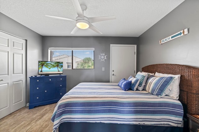 850 A1A Beach Blvd Unit 3, Saint Augustine Beach, FL 32080 - bedroom featuring light wood-style flooring, a textured ceiling, ceiling fan, and a closet