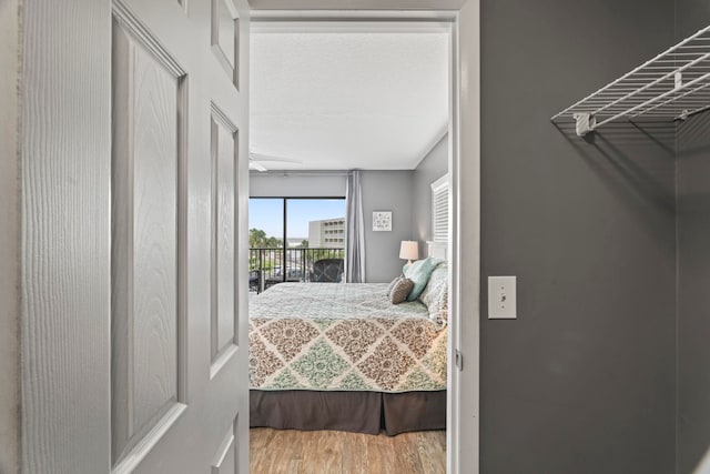 bedroom featuring access to outside and hardwood / wood-style flooring