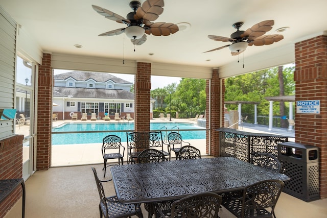 view of patio with ceiling fan and a community pool