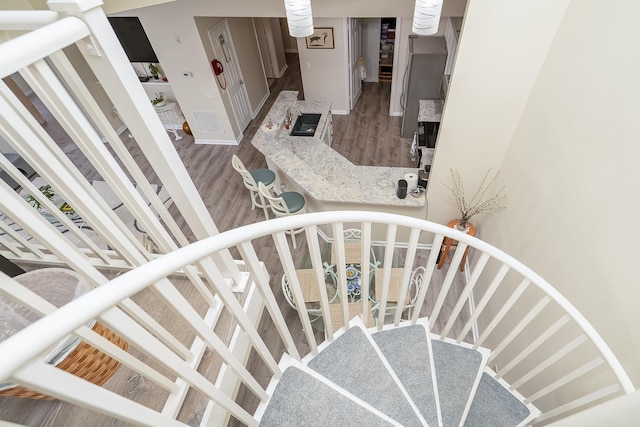 staircase featuring hardwood / wood-style flooring and sink