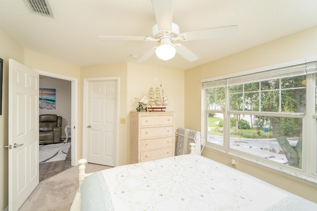 carpeted bedroom with ceiling fan