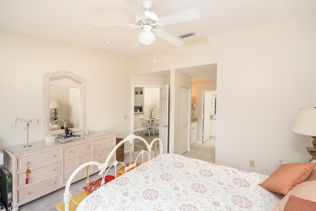 bedroom with ensuite bath and ceiling fan