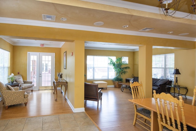 living room featuring ornamental molding, a healthy amount of sunlight, and light hardwood / wood-style floors