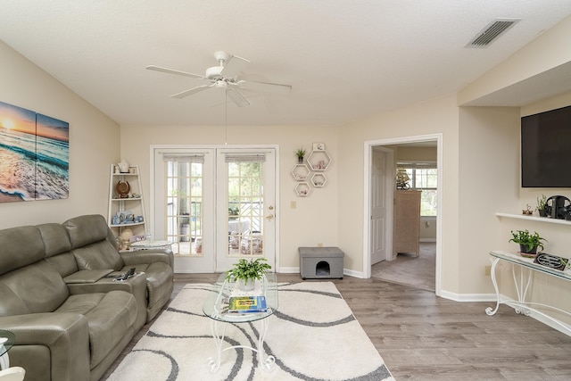 living room featuring light hardwood / wood-style floors and ceiling fan