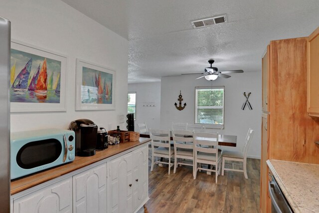237 Riberia St, Saint Augustine, FL 32084 - dining room featuring visible vents, a ceiling fan, a textured ceiling, and wood finished floors