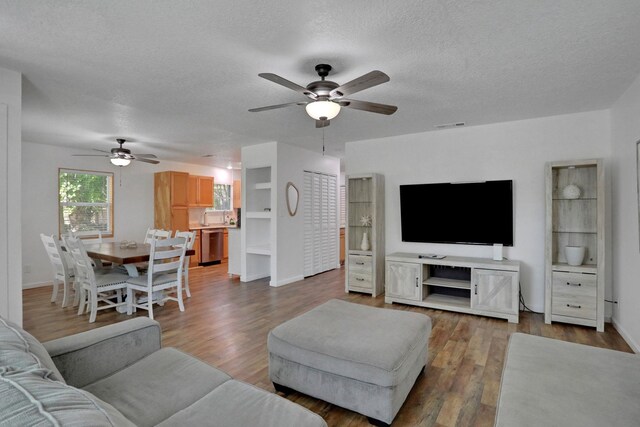 237 Riberia St, Saint Augustine, FL 32084 - living room featuring visible vents, wood finished floors, baseboards, a textured ceiling, and a ceiling fan