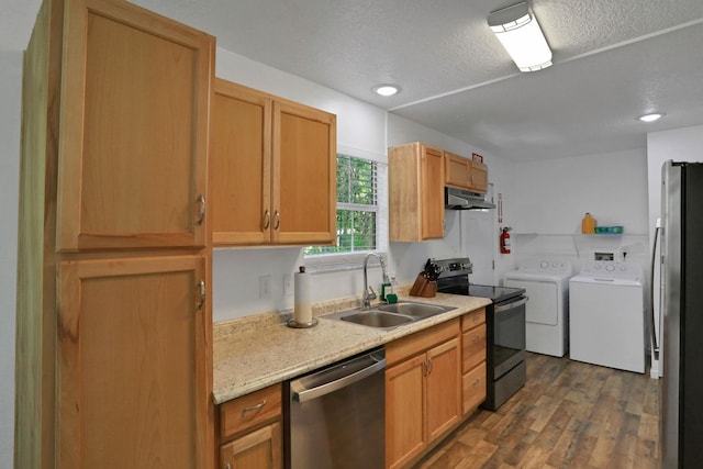 237 Riberia St, Saint Augustine, FL 32084 - kitchen with washer and dryer, a textured ceiling, a sink, dark wood finished floors, and appliances with stainless steel finishes
