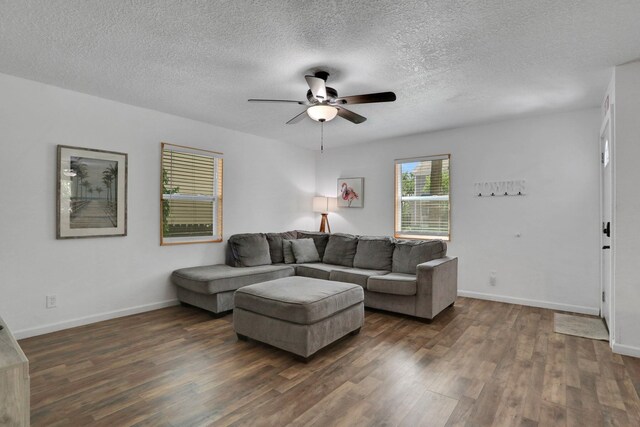 237 Riberia St, Saint Augustine, FL 32084 - living room with dark wood-style flooring, ceiling fan, baseboards, and a textured ceiling