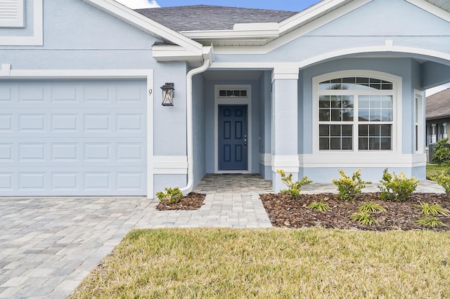 view of exterior entry with a garage