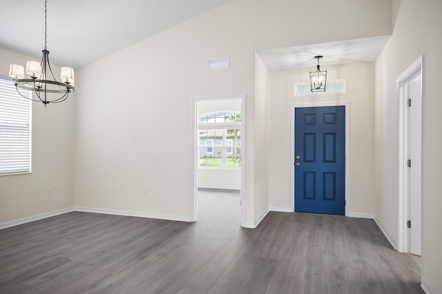 foyer featuring dark hardwood / wood-style flooring and a notable chandelier