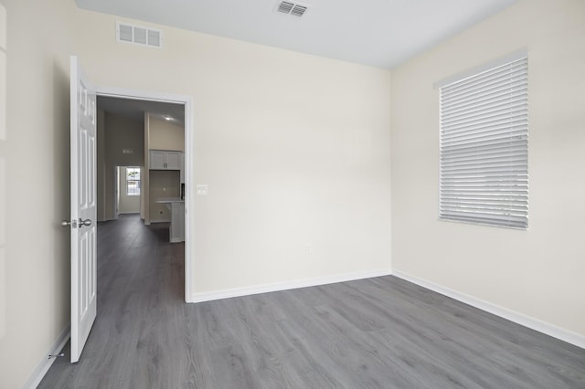 spare room featuring dark hardwood / wood-style flooring