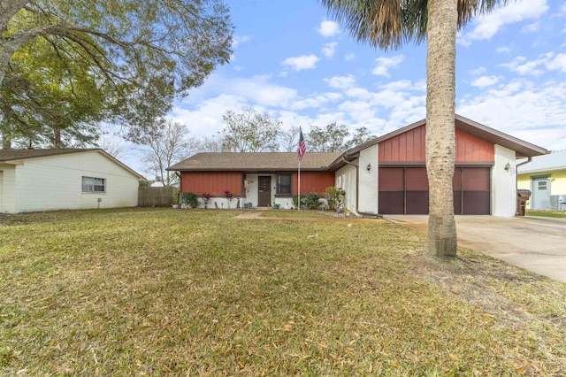 ranch-style house featuring a front lawn and a garage