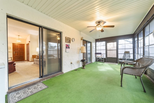 sunroom featuring ceiling fan