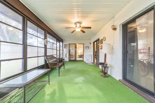 sunroom featuring ceiling fan