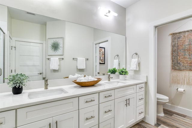 bathroom featuring hardwood / wood-style floors, vanity, and toilet