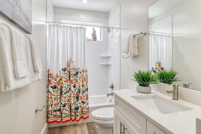 full bathroom with hardwood / wood-style floors, vanity, toilet, and shower / bathtub combination with curtain