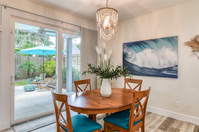 dining area featuring light hardwood / wood-style floors and a notable chandelier