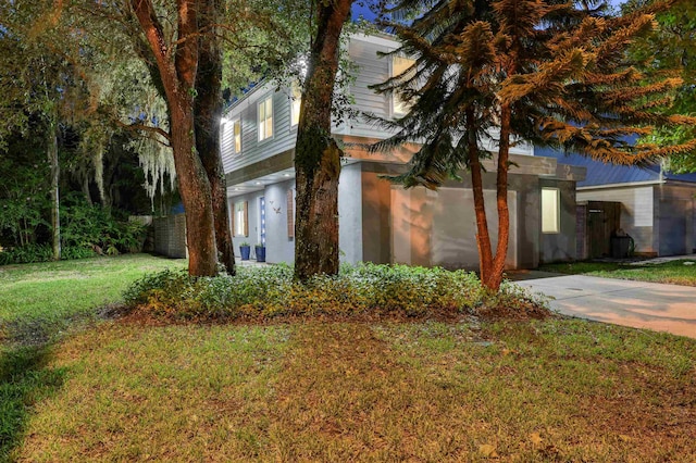 view of property exterior with a yard and a garage