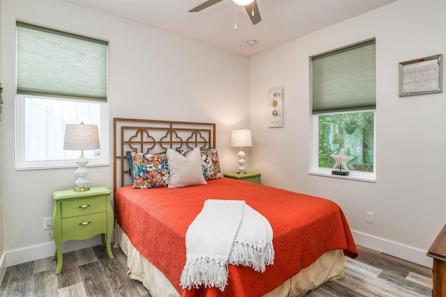 bedroom with hardwood / wood-style floors, multiple windows, and ceiling fan