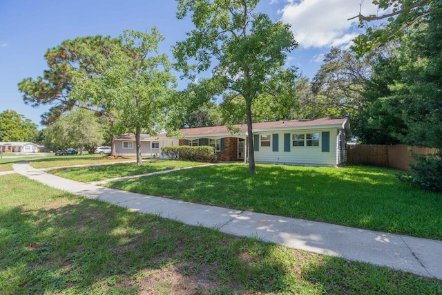 ranch-style home with a front lawn