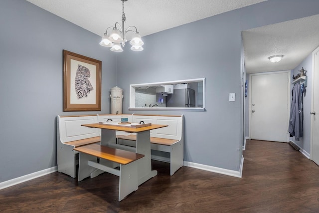 640 N Nova Rd Unit 117, Ormond Beach, FL 32174 - dining room featuring a textured ceiling, a chandelier, and dark wood finished floors
