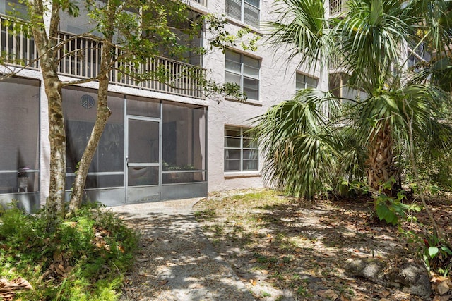 640 N Nova Rd Unit 117, Ormond Beach, FL 32174 - back of house featuring a sunroom, stucco siding, and a balcony