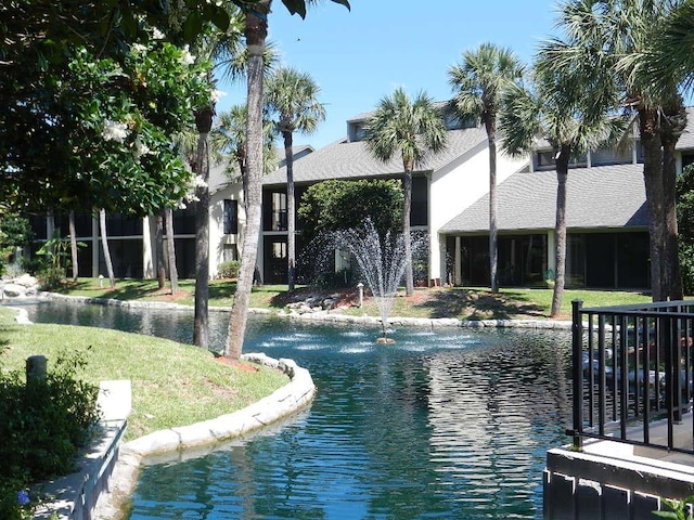 exterior space with a water view and a lawn