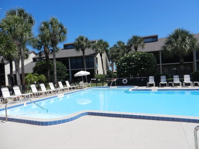 pool featuring a patio area and fence