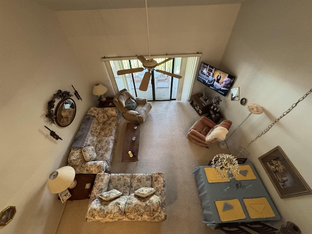 living area featuring carpet floors and a ceiling fan