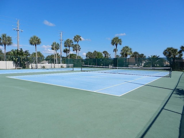 view of tennis court with fence