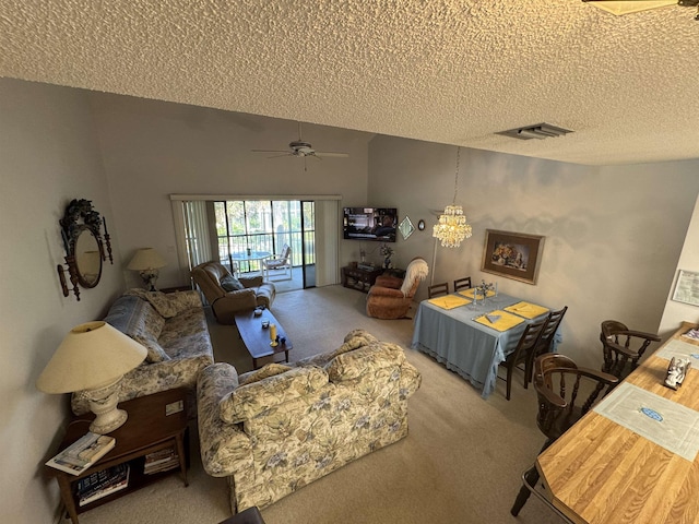 carpeted living area featuring a textured ceiling, lofted ceiling, visible vents, and a ceiling fan