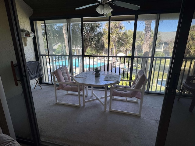 sunroom / solarium with a wealth of natural light and a ceiling fan