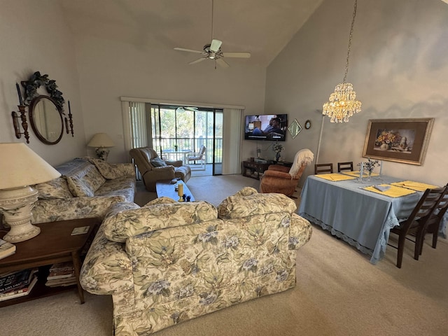 living room featuring high vaulted ceiling, carpet, and ceiling fan with notable chandelier