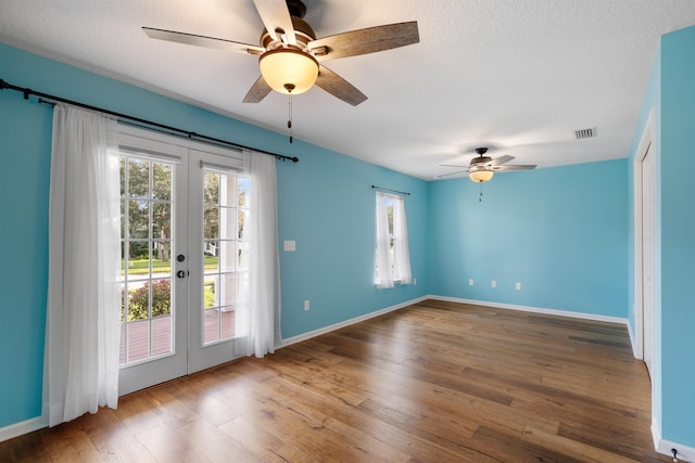 spare room featuring french doors, a textured ceiling, ceiling fan, and hardwood / wood-style floors