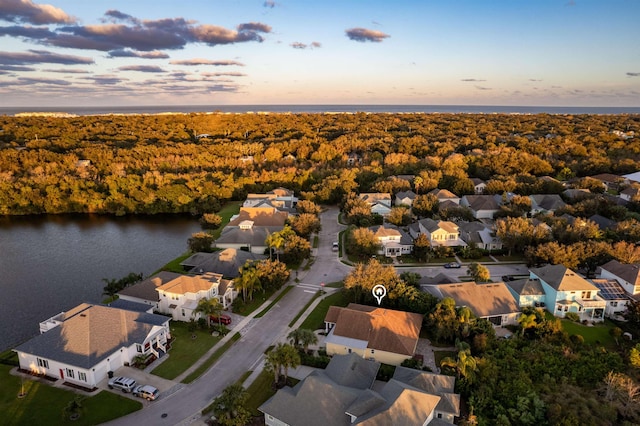 aerial view at dusk with a water view