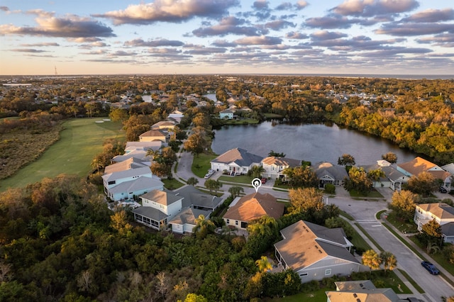 aerial view at dusk with a water view