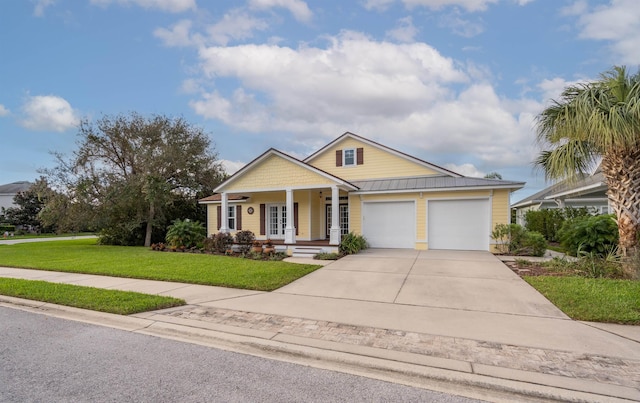 craftsman house featuring a garage, covered porch, and a front yard