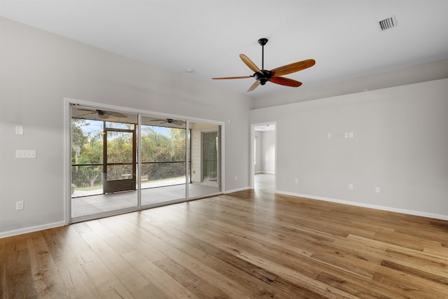 empty room with ceiling fan and light hardwood / wood-style flooring