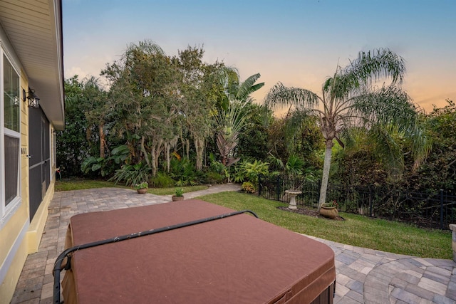 patio terrace at dusk with a hot tub