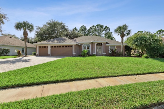 ranch-style house featuring a garage and a front yard