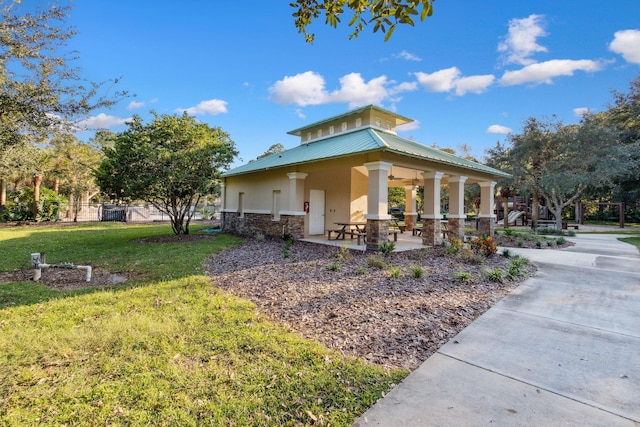 view of side of property with a yard and a patio